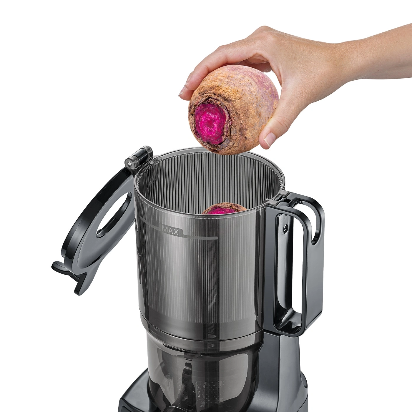 Person placing beetroot into juicer. Close-up, isolated on white background.