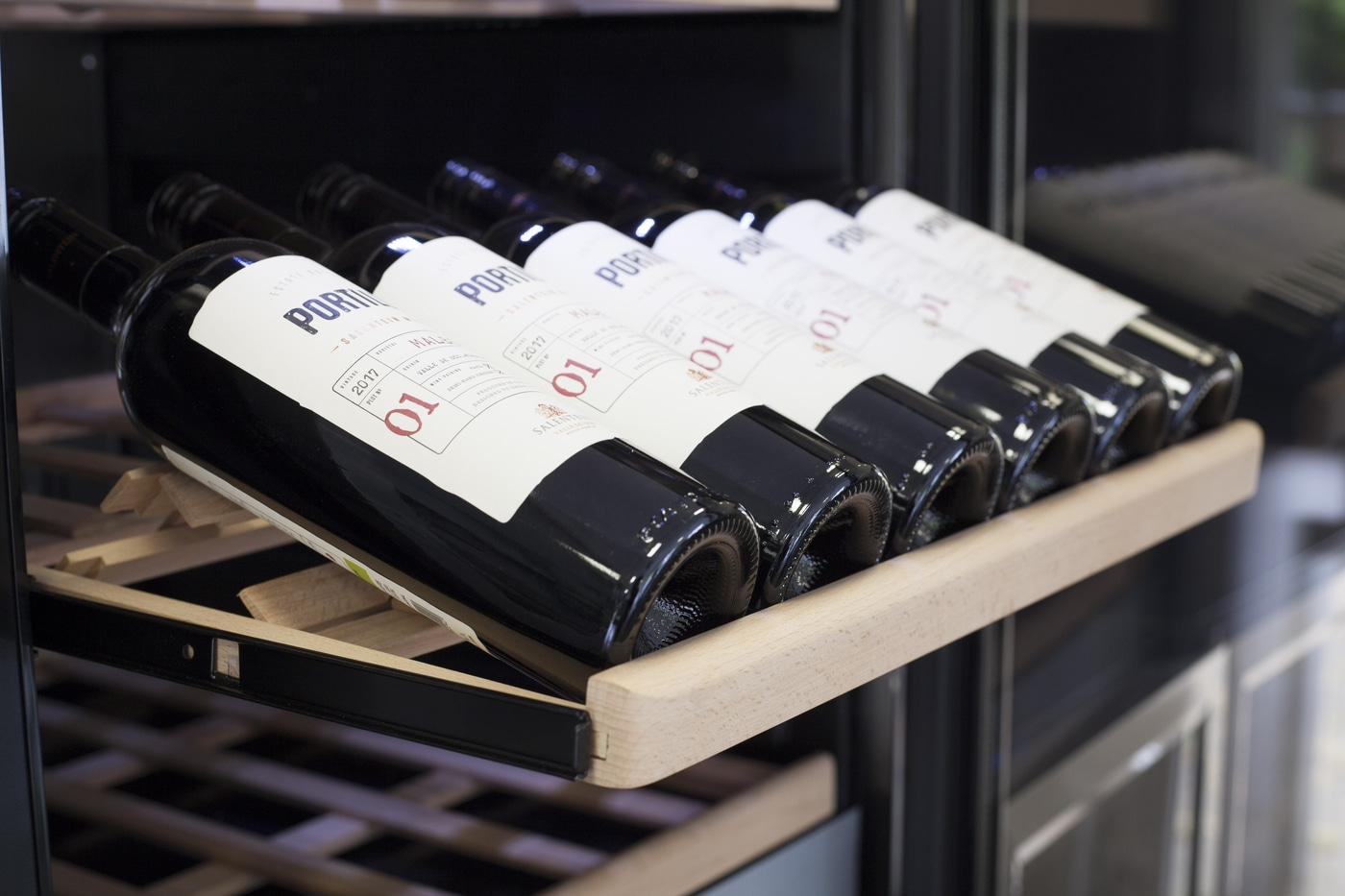 Wine bottles in a wine cooler, labeled Salentein, vintage 2017, Malbec, with the number 01.