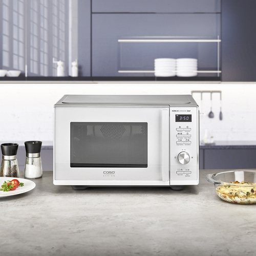 White microwave oven with control panel and display on a kitchen countertop.