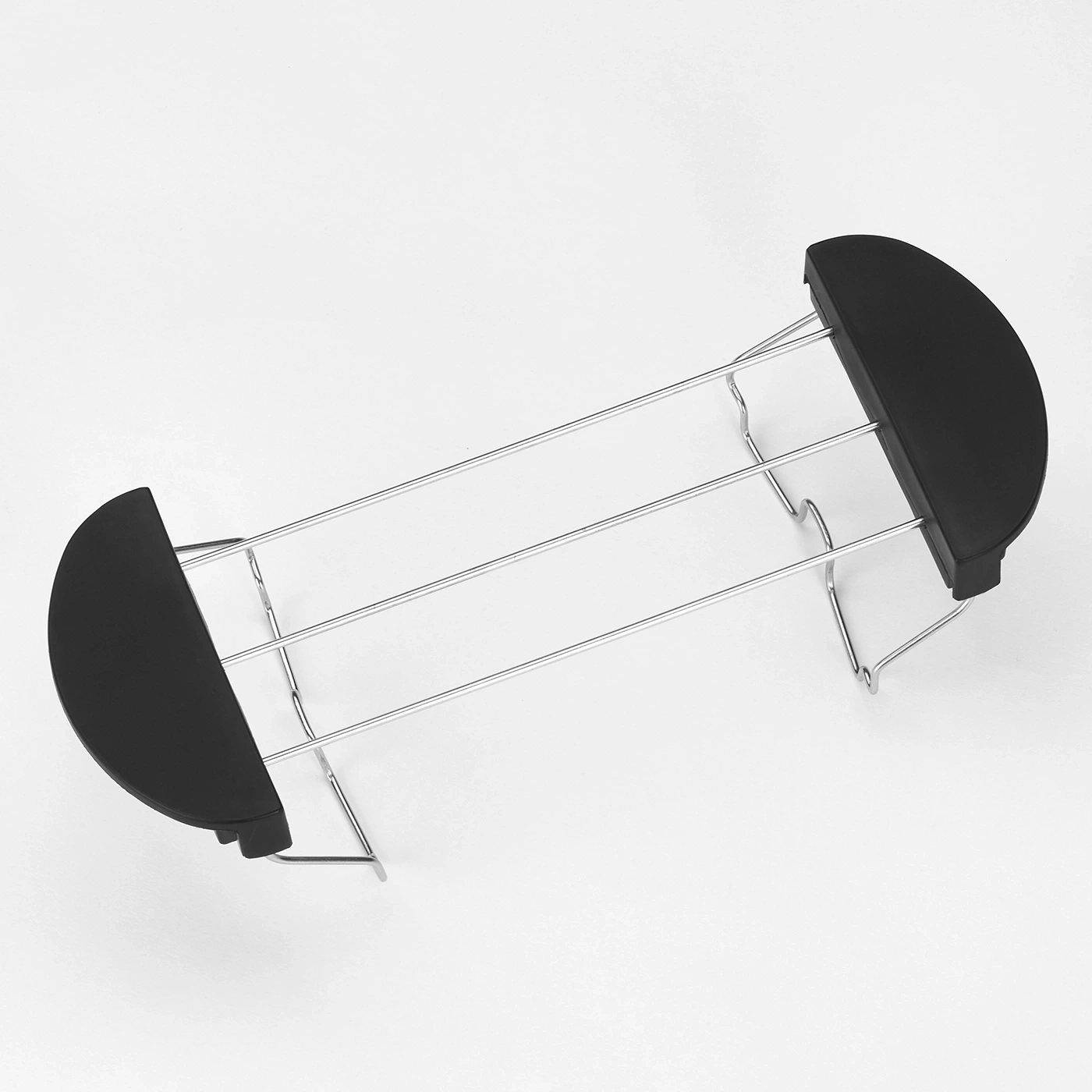 Black toaster rack on white background, metal and plastic construction.