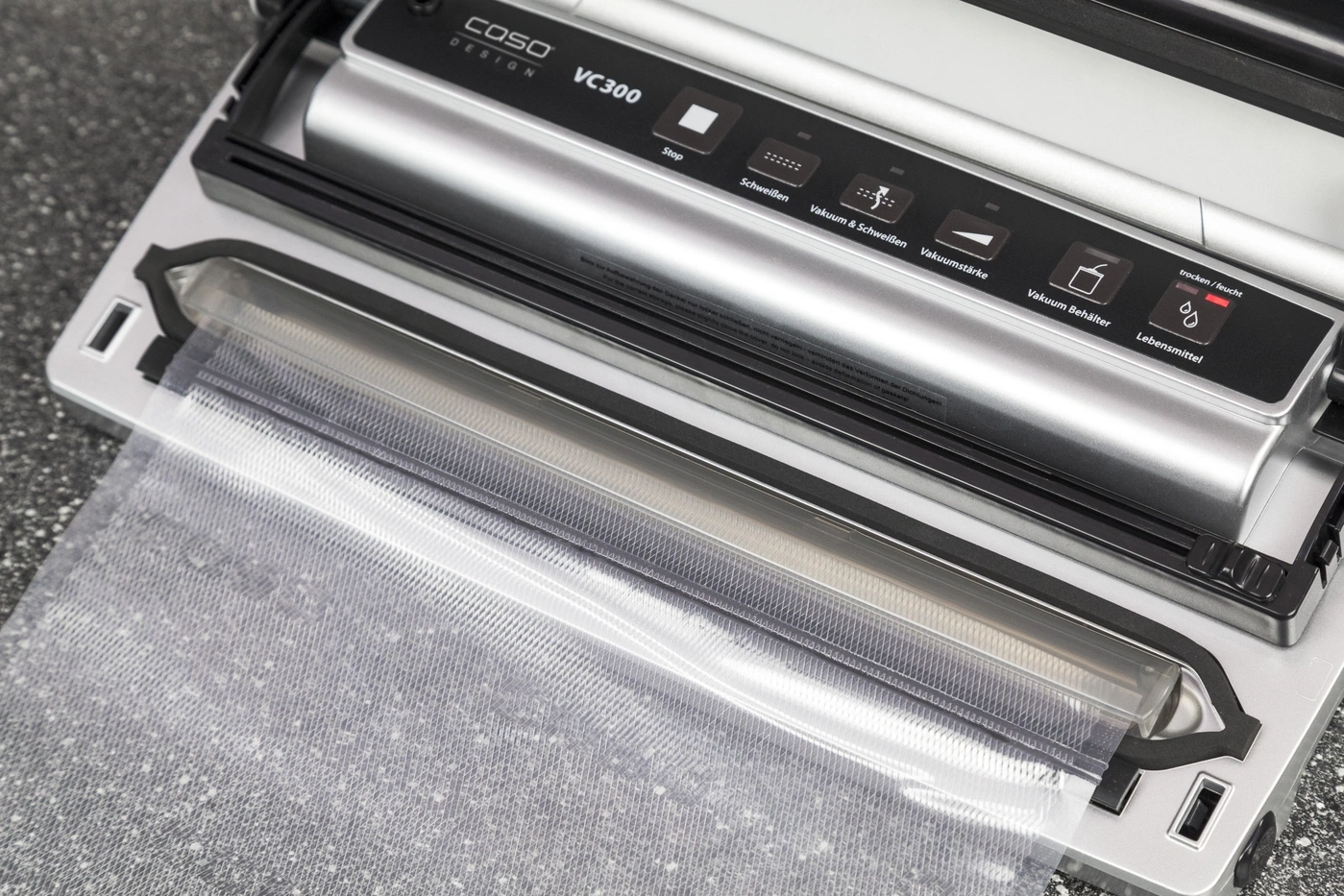 Vacuum sealer with control panel and bag, ready to vacuum seal food items.