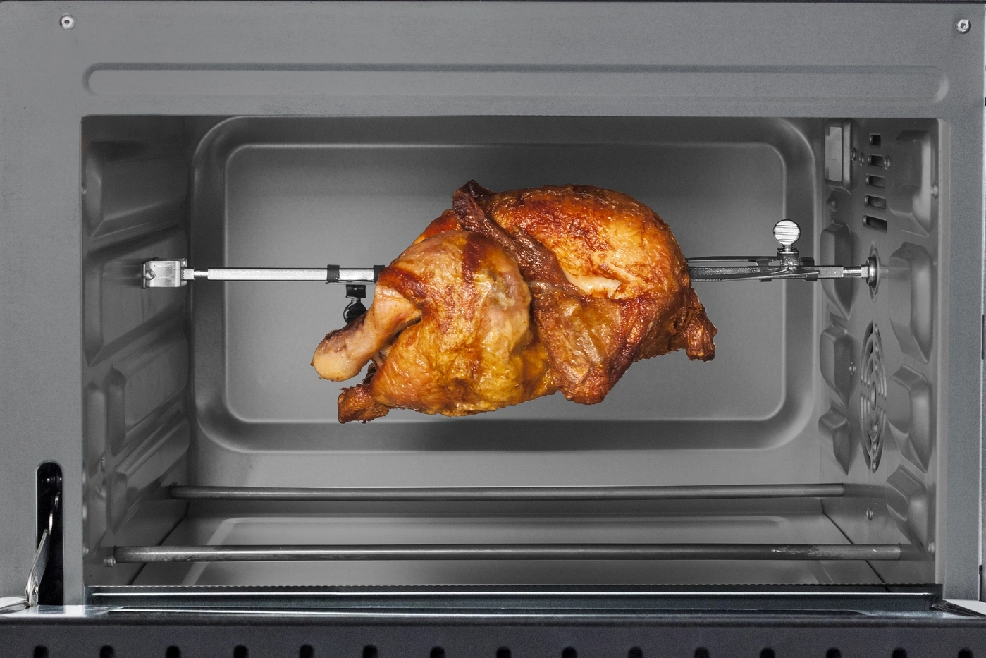 Roasted chicken in oven, golden brown, on rotisserie, ready to eat, delicious, crispy skin