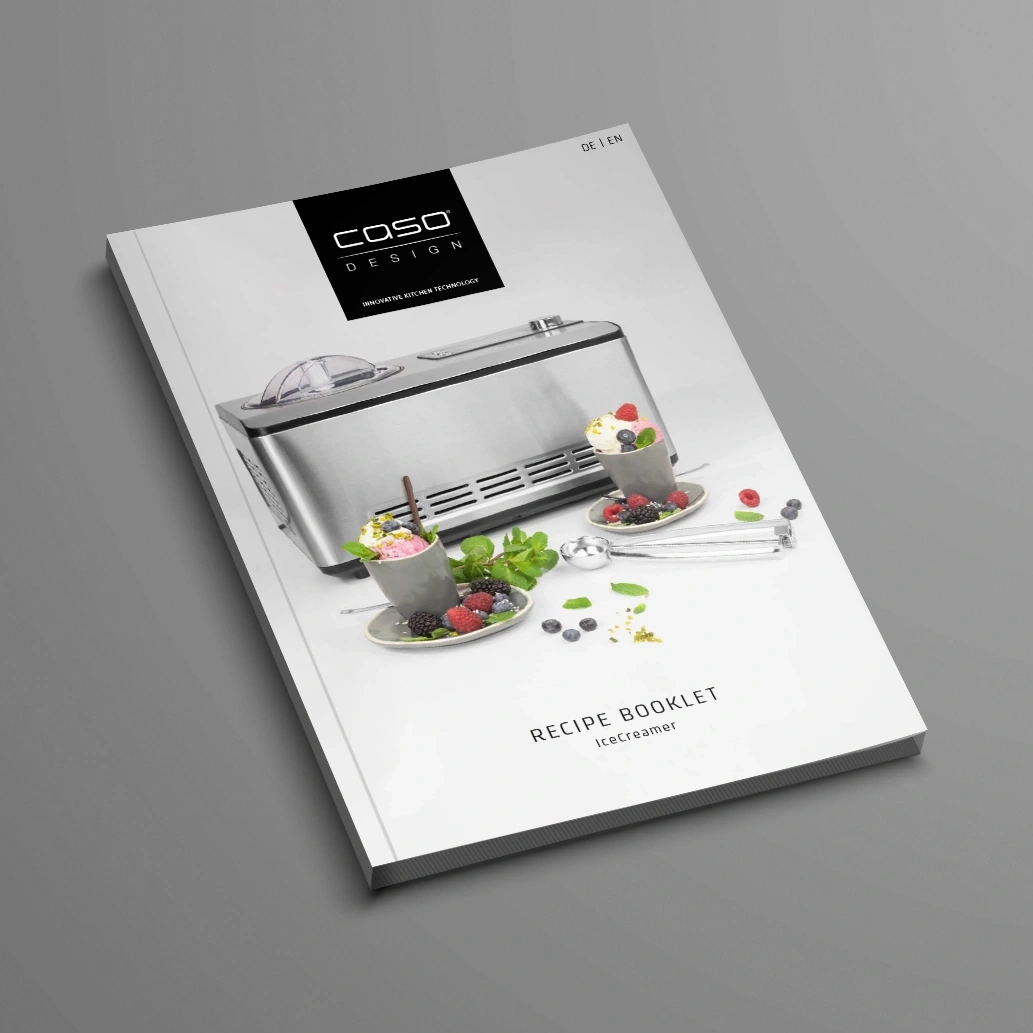 Ice cream recipe booklet with ice cream machine and ice cream cups with berries
