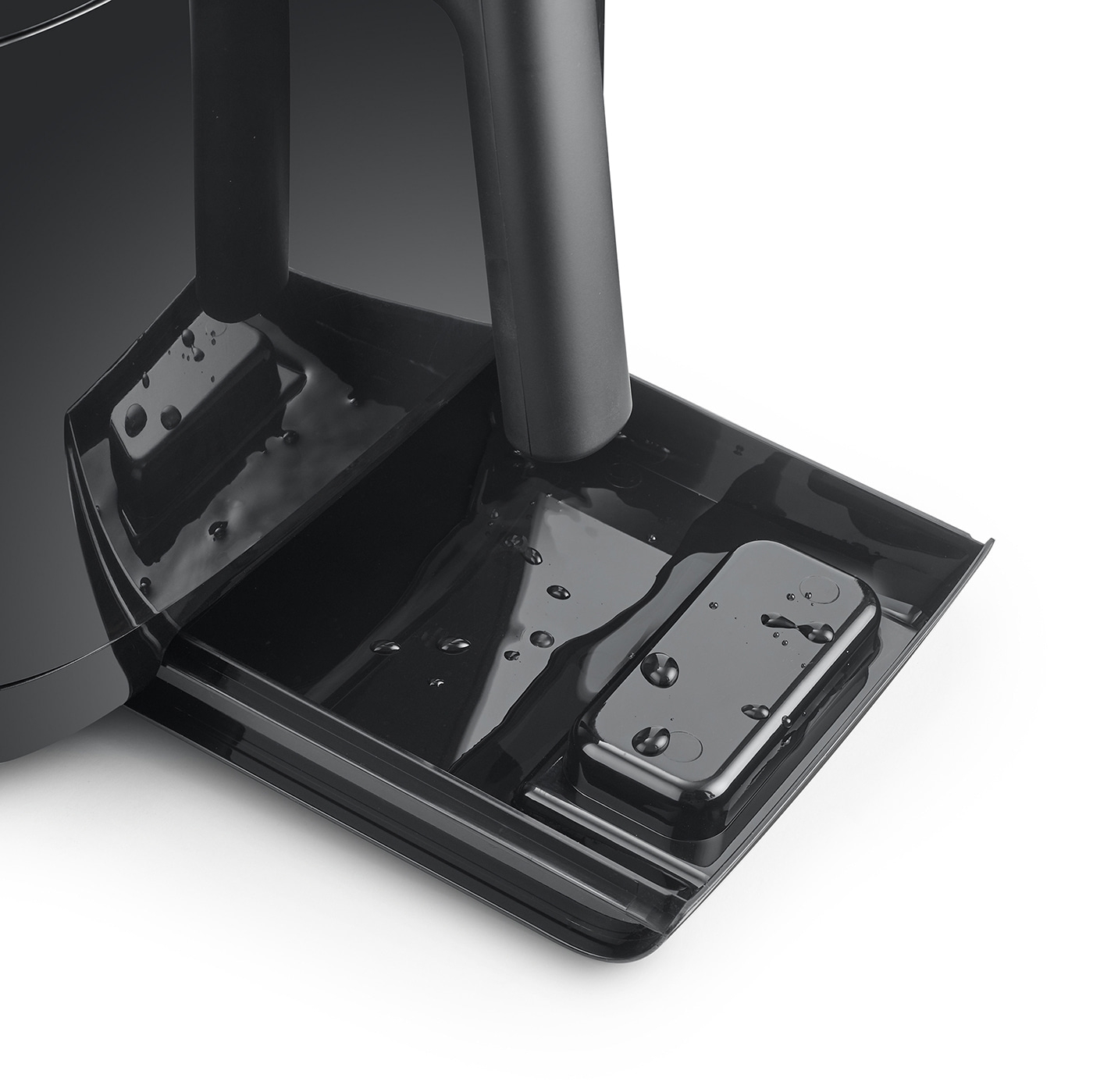 Black machine with water and a rectangular part, close-up shot, shiny surface.