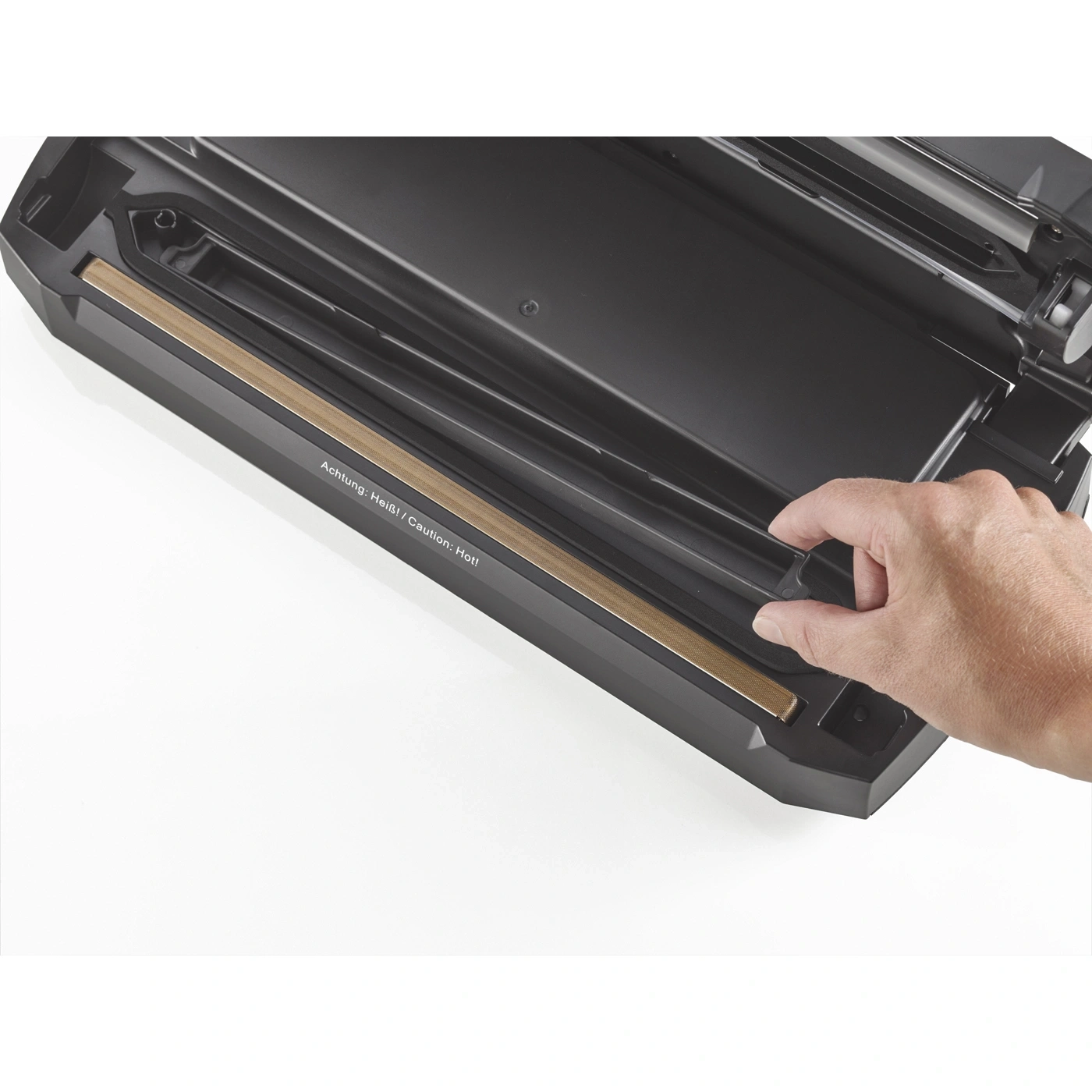 Scelleuse sous vide noire avec une main l'actionnant, sur fond blanc, attention chaud.