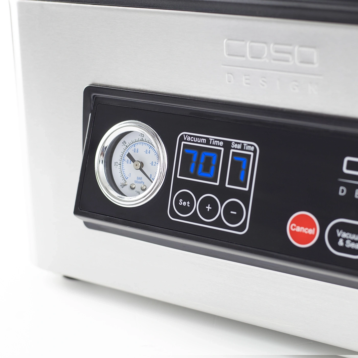 Close-up of a vacuum sealer machine with a pressure gauge and digital display.