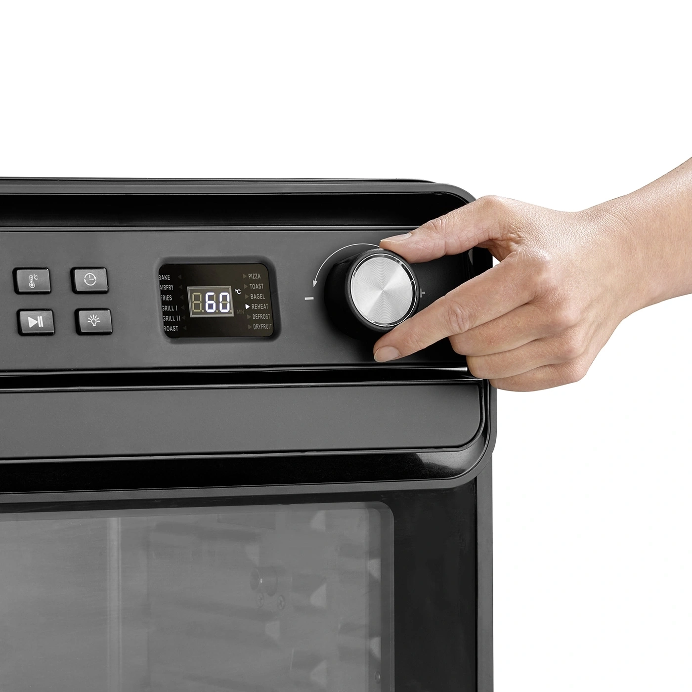 Oven with control panel and hand turning a knob to set the temperature.