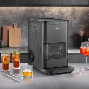 Ice maker with glasses and ice cubes on a countertop