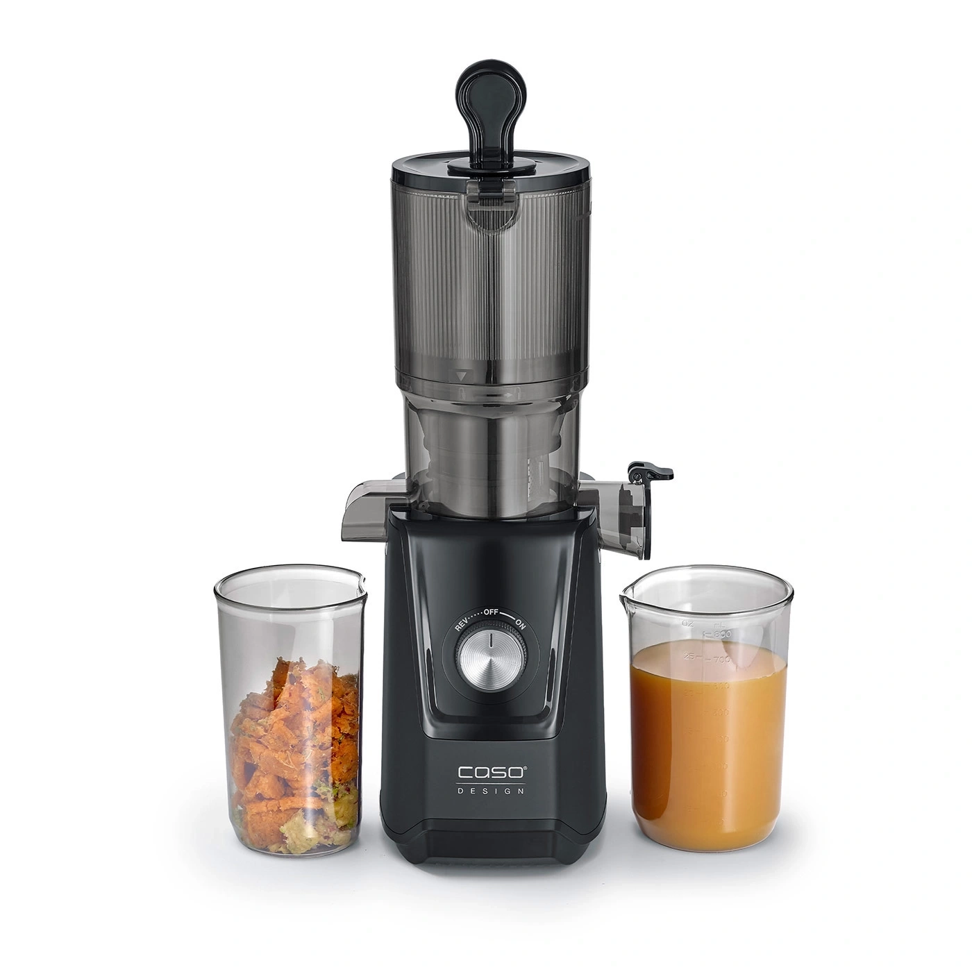 Black juicer with two glasses, one with juice, one with vegetables, on white background.