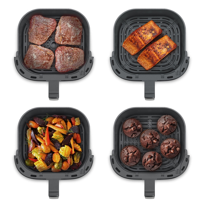 Luftfritteuse mit Fleisch, Fisch, Gemüse und Muffins. Kochen in der Küche.