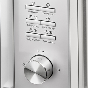 Microwave control panel with knob for functions like microwave, grill, and defrost.