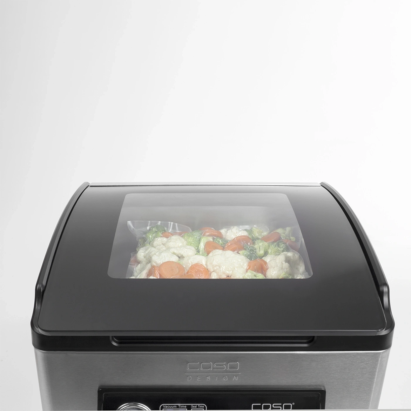 A vacuum sealer with vegetables in a bag.