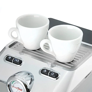 Nahaufnahme einer Espressomaschine mit zwei weißen Tassen auf der Oberseite.