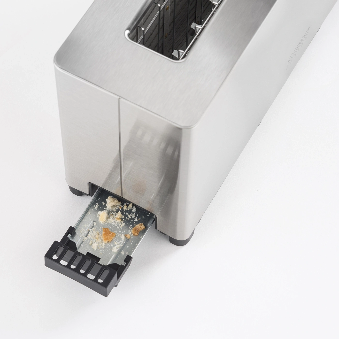 Toaster with crumb tray, stainless steel, bread crumbs, close-up, clean