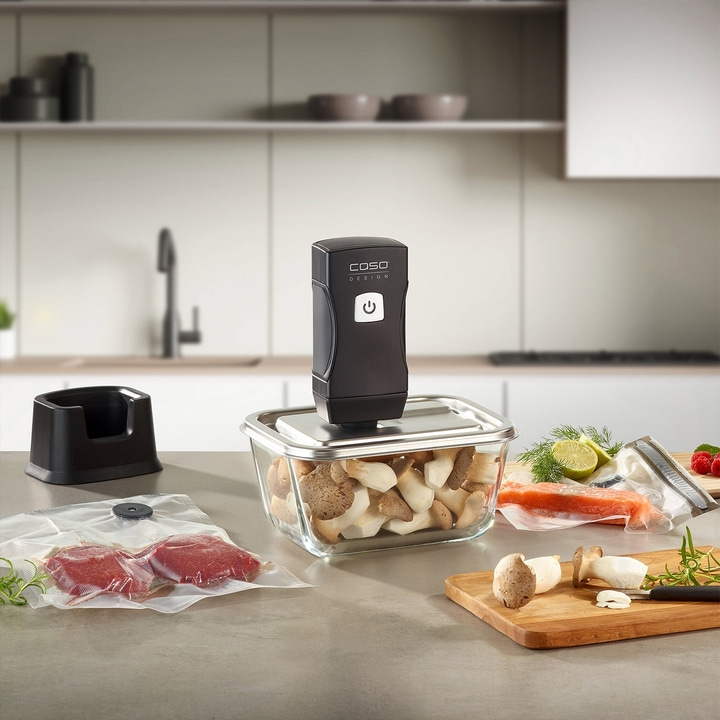 Vacuum sealer with food on a kitchen countertop. Cooking and food preparation.