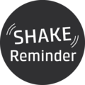 Kreisförmiges Logo mit weißem Text 'SHAKE Reminder' auf grauem Hintergrund.